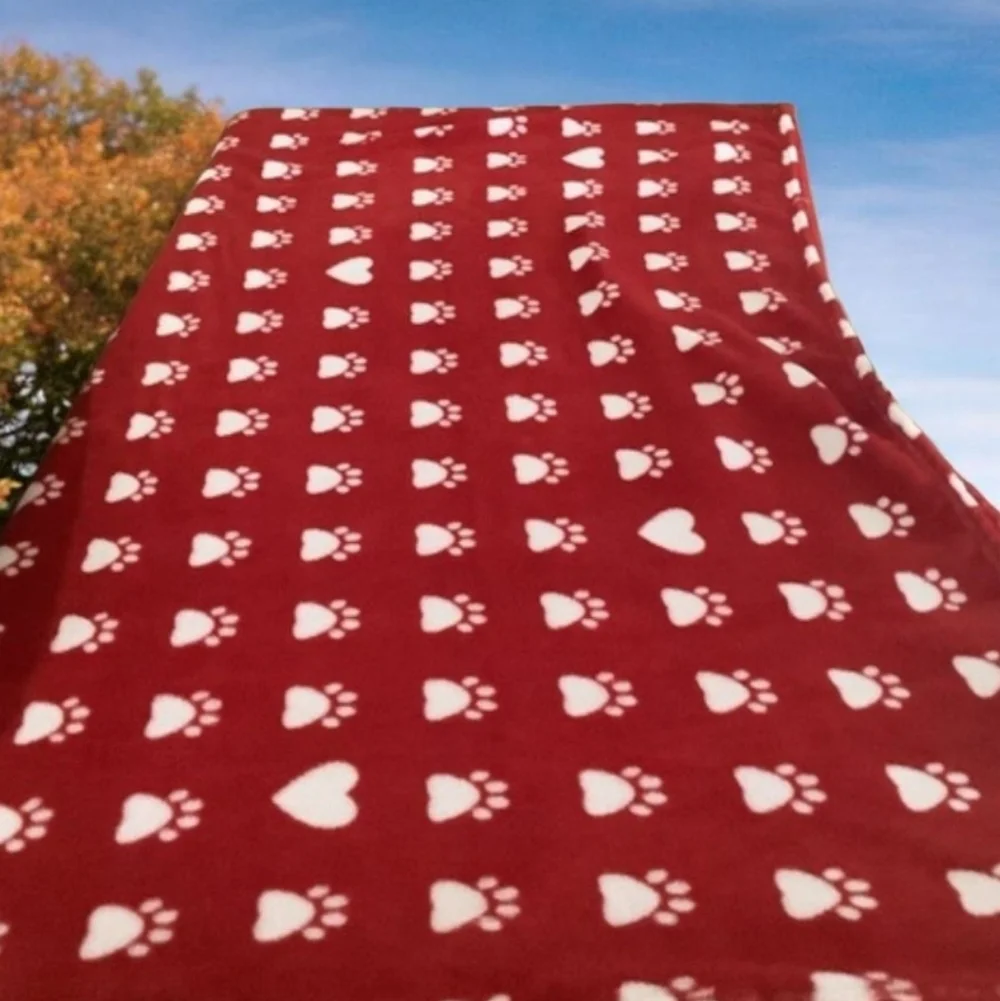 Doggie blanket a red & white with prints on it soft & cozy. 77”x50” clea…